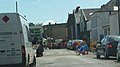 English: Castle Street, East Cowes, Isle of Wight, seen from the junction with Old Road. While the road was not officially closed by the adjacent East Cowes Waitrose construction, it had been temporarily blocked when seen here. The road was single file anyway due to the fence that is visible, and a construction vehicle was in the way while it did something. Things began to be moved out of the way shortly afterwards, but not before people had started turning around to take alternative routes.