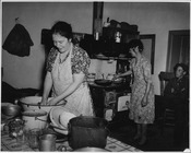 New Mexico woman cooking on a stove typical of North American kitchens, in 1941