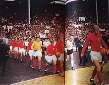 Bobby Moore (far right) leading the England team out on to the pitch to play the 1966 FIFA World Cup Final against West Germany at Wembley Stadium England germany entering pitch.jpg
