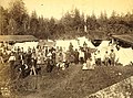Group of Puget Sound Indians, possibly hop pickers, with tents and buildings in background, Washington, ca 1889 (BOYD+BRAAS 87).jpg