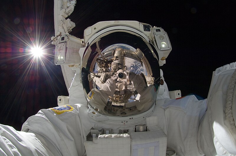A space selfie taken by astronaut Akihiko Hoshide during a space walk at the International Space Station. Show another