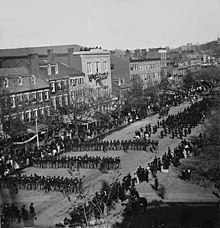 Military units marching down Pennsylvania Avenue in Washington D.C., during the state funeral for Abraham Lincoln on April 19, 1865 Lincolns funeral on Pennsylvania Ave. (LOC) (3252915551).jpg