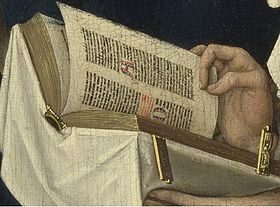 Detail showing the prayer book, likely a book of hours, decorated with white cloth and gold clasps. M Reading Detail.jpg