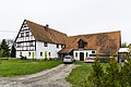 Residential stable house, side building and barn of a three-sided courtyard