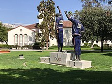 The Victory Salute monument depicts alumni Tommie Smith and John Carlos in their historic 1968 protest. San Jose State University Central Classroom Building and grounds.jpg