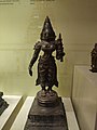 Pictures clicked in Telangana State Archaeology Museum, Hyderabad, India.Title: SrideviProvenance: ManuboluEra: 18th CADSize: 50 x 20 cmAcc. no. : 2000 - 44Sri devi standing in tribhanga on padma pitha is holding a nilotpala in her left hand and the right one is shown in gajabastha. She is wearing kirita, tatankachakra, kantakamala, baras, skandamala, keyura, kankana, angulika, kuchabandha, mekhala and nupura.