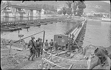 British troops cross the River Seine over a Bailey bridge at Vernon, 27 August 1944. The British Army in North-west Europe 1944-45 BU185.jpg