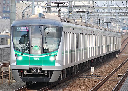 A Tokyo Metro 16000 series train operating a through service on the JR East Jōban Line, an example of high-density commuter rail in Japan.