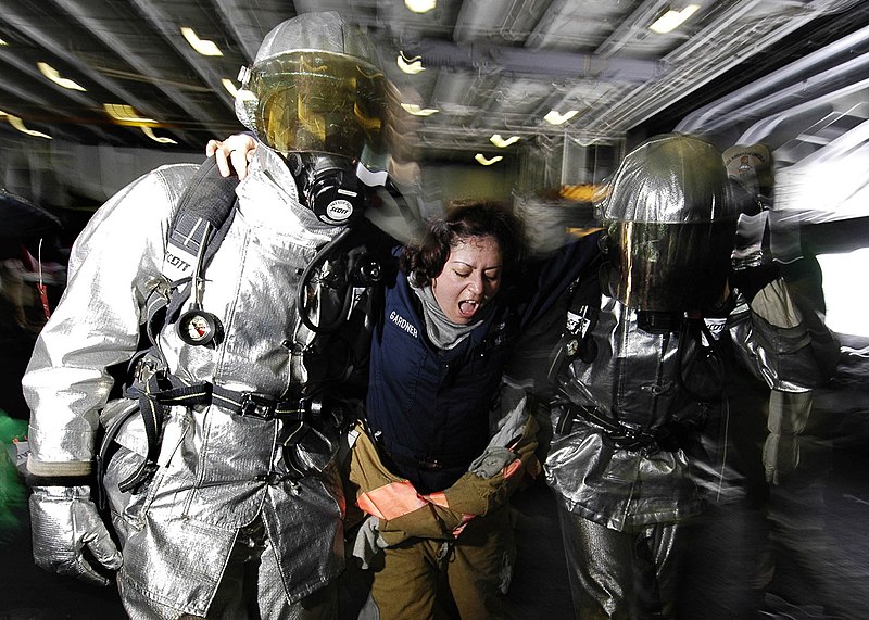 File:US Navy 060315-N-7981E-035 Fire party members help Hull Maintenance Technician 2nd Class Holly Gardner to safety, during general quarters (GQ) drill.jpg