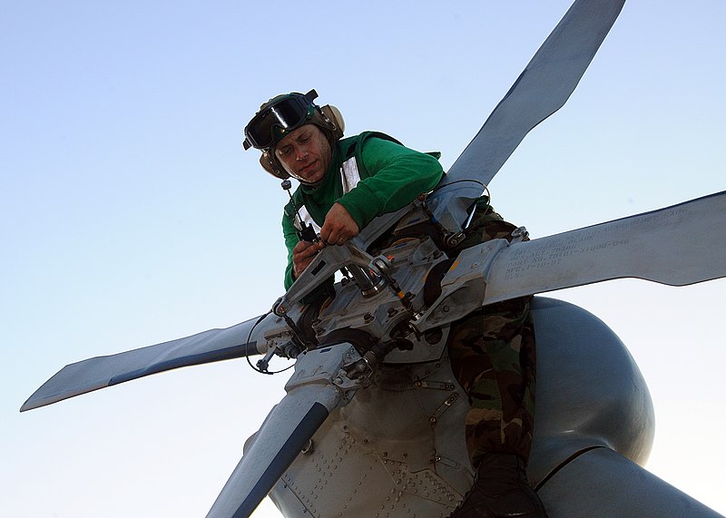 File:US Navy 100320-N-4649B-147 Aviation Machinist's Mate 1st Class Andrew Van Norman, from Yucaipa, Calif., conducts maintenance on a tail rotor head aboard the multipurpose amphibious assault ship USS Bataan (LHD 5).jpg