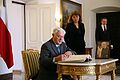 Valdas Adamkus writing a note in the condolence book in the Presidential Palace in Warsaw after the death of Lech Kaczyński.