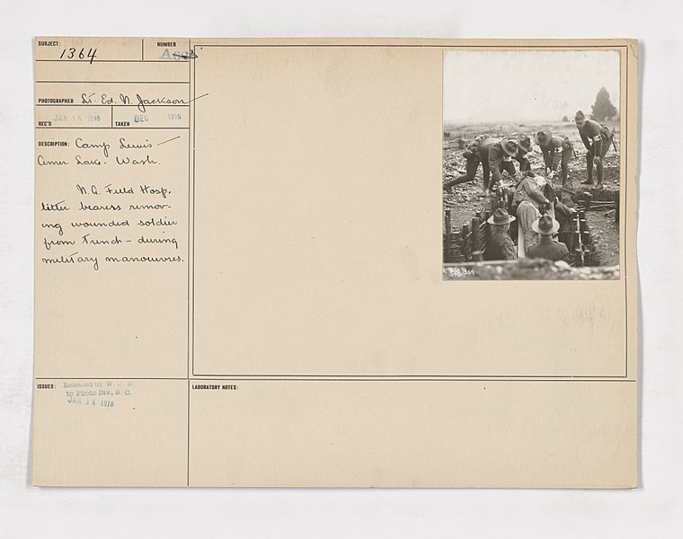 File:111-SC-1364 - Camp Lewis, Washington - Soldier being removed from the trenches on a stretcher - Photograph taken in a training camp and the soldier on the stretcher volunteered to act the part of a wounded man - NARA - 55164061.jpg