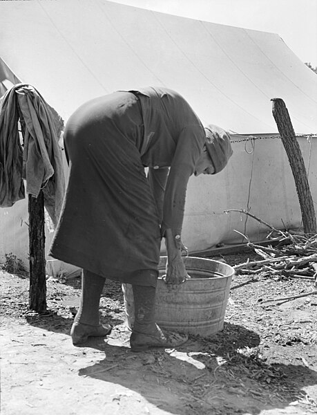 File:A grandmother washing clothes in a migrant camp, Stanislaus County, California, 8b33499.jpg