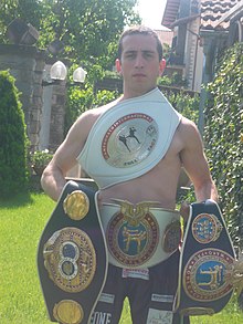 Alessandro Riguccini undisputed champion in kickboxing Alex 4 belt.jpg