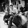 American officer and French partisan crouch behind an auto during a street fight in a French city, ca HD-SN-99-02714.jpg