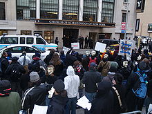 Guy Fawkes-masked protesters gather at the Scientology center in Times Square, New York City, on February 10, 2008. Anonymous Scientology 6 by David Shankbone.JPG