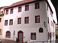 Wohnhaus in Ecklage, mit Seitenflügel und Stützmauer mit Ziergitter