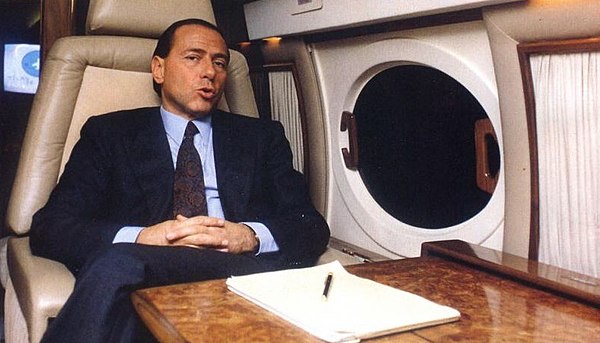 Berlusconi in his private jet aircraft in the 1980s