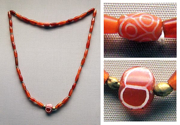 The etched carnelian beads in this necklace from the Royal Cemetery dating to the First Dynasty of Ur were probably imported from the Indus Valley. Br