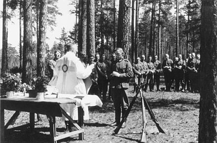 German Christian Field Service for German Soldiers during WWII, the army chaplain gives segen to the German troops with "God with us" on their belt buckle,[47][48] 1941; 95% of all Germans being Christians[48]