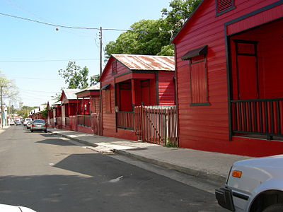 Distinctive red-and-black striped cottages at Calle 25 de Enero