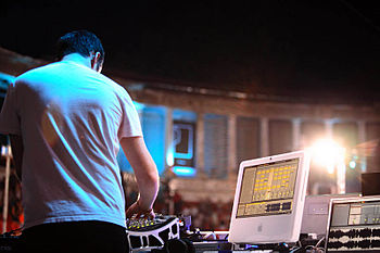 Sasha playing a DJ set using Ableton Live running on an iMac G5. DJ Sasha at Arenele Romane, Bucharest (2006) (rear view).jpg