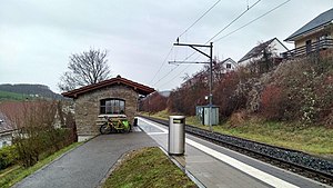 Single-tracked railway line with small stone shelter