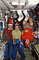 Expedition 16 crew members pose for a Christmas photo in the Zvezda Module of the ISS.jpg