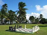 A giant outdoor chessboard, with pieces about three feet tall.