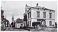 Langenlonsheim (Bad Kreuznach), vor 1910 mit Blick in die Hauptstraße. Im Vordergrund rechts, das alte 1877-1878 errichtete neo-gotische Verwaltungsgebäude der Bürgermeisterei (Architekt Carl Conradi) , 1988 abgebrochen.jpg
