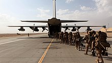 HELMAND PROVINCE, Afghanistan - Marines and sailors with Marine Expeditionary Brigade - Afghanistan load onto a KC-130 aircraft on the Camp Bastion flightline, Oct. 27, 2014. The Marine Corps ended its mission in Helmand province, Afghanistan, the day prior and all Marines, sailors and service members from the United Kingdom withdrew from southwestern Afghanistan. Photo by: SSgt John Jackson Marine Corps ends mission in Afghanistan.jpg