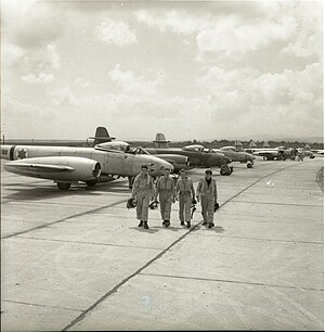 Four Israeli fighter pilots walking in front of their Gloster Meteor F.8 fighter jets of 117 Squadron "First Jet" in 1953 or later at Ramat David Airbase Meitar Collection (997009327258905171.jpg