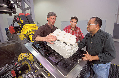 Molded pulp uses recycled newsprint to form package components.  Here, researchers are molding packaging from straw[1]