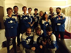 A group of volunteers and staff involved in the strategy process wearing special Canadian-inspired hockey jerseys