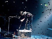 Bellamy performing with Muse at Cardiff International Arena (1 December 2003)