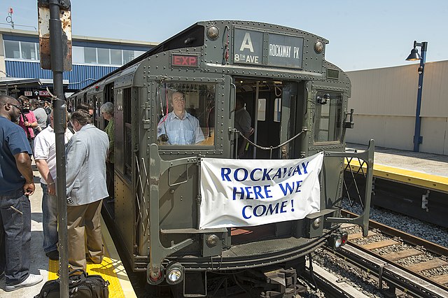R1 car 100 on the IND Rockaway Line, celebrating the restoration of service to the Rockaways in 2013