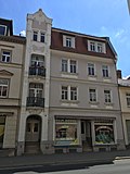 Residential building with shop in closed development