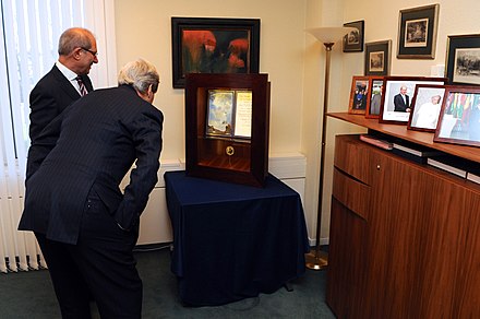 OPCW Director-General Ahmet Üzümcü shows U.S. Secretary John Kerry the Organization's Nobel Peace Prize, 24 March 2014