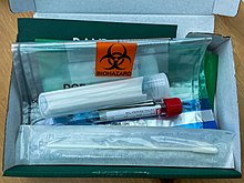 A Randox PCR home test kit in the UK, showing the swab, and multi-layer packaging to deliver it to the lab Randox COVID-19 PCR home test kit.jpg