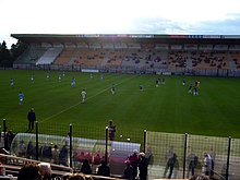 Photographie d'une scène d'un match de football vu des tribunes.