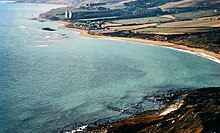 1970 view of West Ringstead from White Nothe, with Ringstead Bay in the foreground and the two radar masts of RAF Ringsteadin the distance Ringstead Bay c.1970.jpg