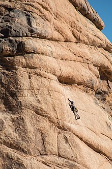 A climber using a top rope to protect a climb Rock climber (16023882834).jpg