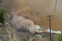 A Sikorsky S-64 Skycrane flies over the fire on July 25th. Sand-Fire-July-25.jpg