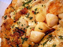 A close-up view of a seafood pizza prepared with scallops, shrimp, calamari and many other ingredients Seafood pizza close-up.jpg