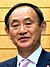 Yoshihide Suga cropped 2 Joint Press Announcement of the Okinawa Consolidation Plan.jpg