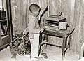 African-American child plays with phonograph in his cabin home. He will be benefited by the Food Security Administration resettlement project. - DPLA - 1014def664ab171c19c86ebd9fb6b2f4.jpg