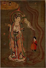 Bodhisattva montrant la voie. Vers 875; couleurs sur soie, 80.5 × 53,8 cm. Trouvé à Dunhuang (Grottes de Mogao, grotte 17). Le bodhisattva montre le chemin à une femme qui tient un brûle parfum dans sa droite et dans sa gauche une fleur de lotus, British Museum.