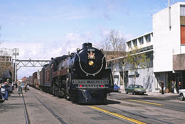 An excursion train pulled by a classic Canadian Pacific steam locomotive visits Jack London Square in 1977