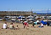 People enjoy the view on New Quay's harbour and pier.