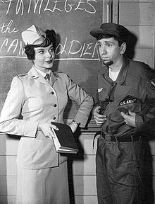 Maynard was not prepared to give up his beard after entering the army. Bob Denver and Kaye Elhardt are featured in this still from the Dobie Gillis episode "The Battle of Maynard's Beard", originally aired April 18, 1961. Bob Denver Dobie Gillis 1961.jpg